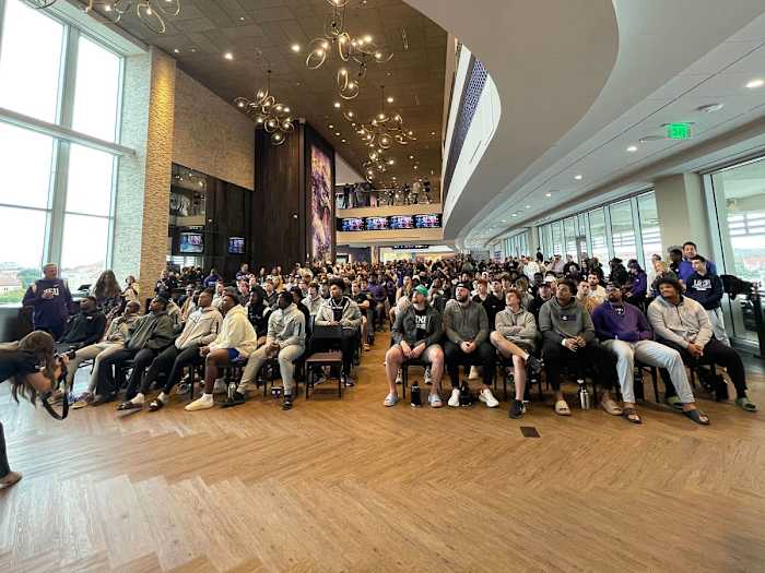TCU players watch the CFP selection show